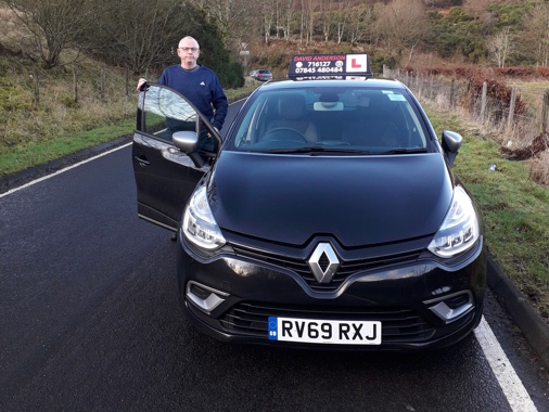 David Anderson standing by his Renault Clio